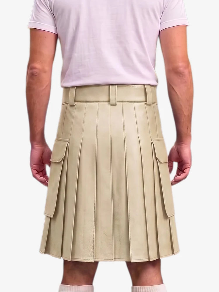 A beige pleated mini kilt with side cargo pockets, modeled from the back on a person wearing a light pink t-shirt and white socks against a plain white background.