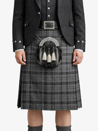 Person wearing a traditional Scottish kilt with a sporran on a white background