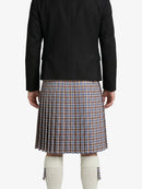 Person wearing a black jacket and plaid kilt on a white background