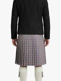 Person wearing a black jacket and plaid kilt on a white background