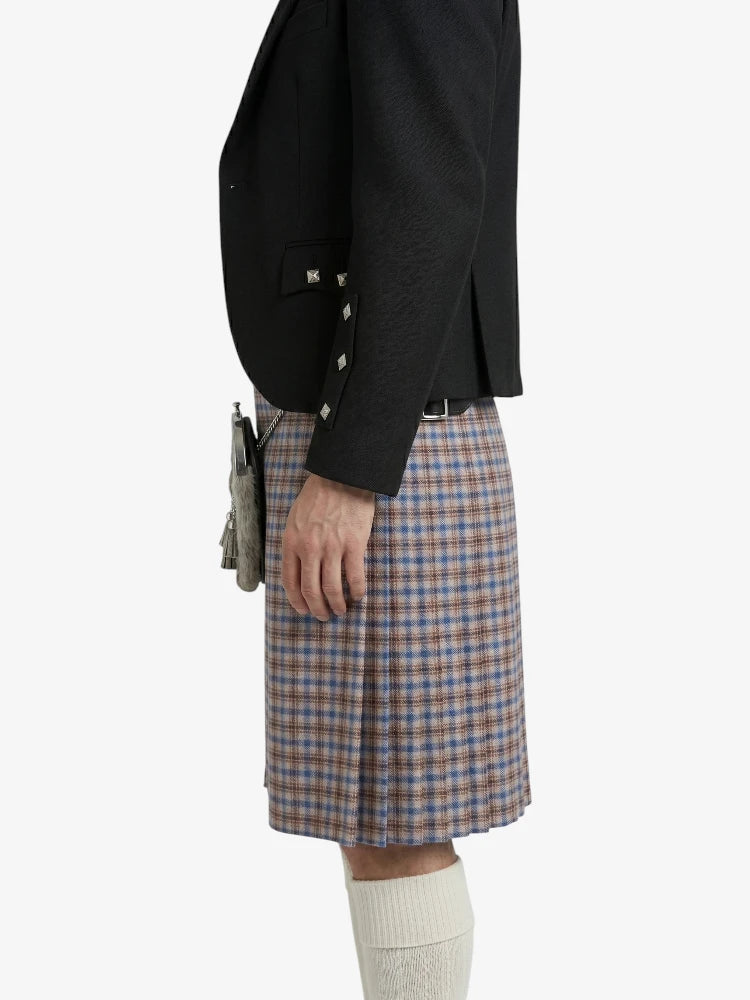 Person wearing a black jacket and plaid kilt on a white background