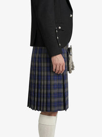 Person wearing a dark jacket and plaid kilt on a white background