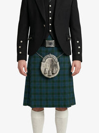 Person wearing a traditional Scottish kilt with a jacket on a white background