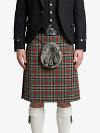 Person wearing a traditional Scottish kilt with a plaid pattern on a white background