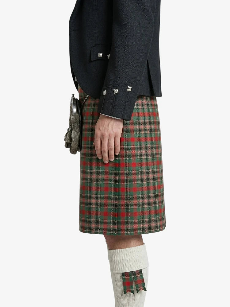 Person wearing a dark gray jacket and green plaid kilt on a white background