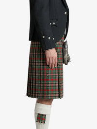 Person wearing a black jacket and green plaid kilt on a white background