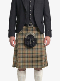 Traditional Scottish kilt with a dark jacket on a white background