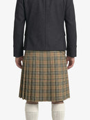 Person wearing a dark coat and plaid kilt on a white background