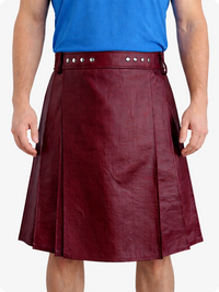 Person wearing a Burgundy leather kilt with a blue shirt on a white background