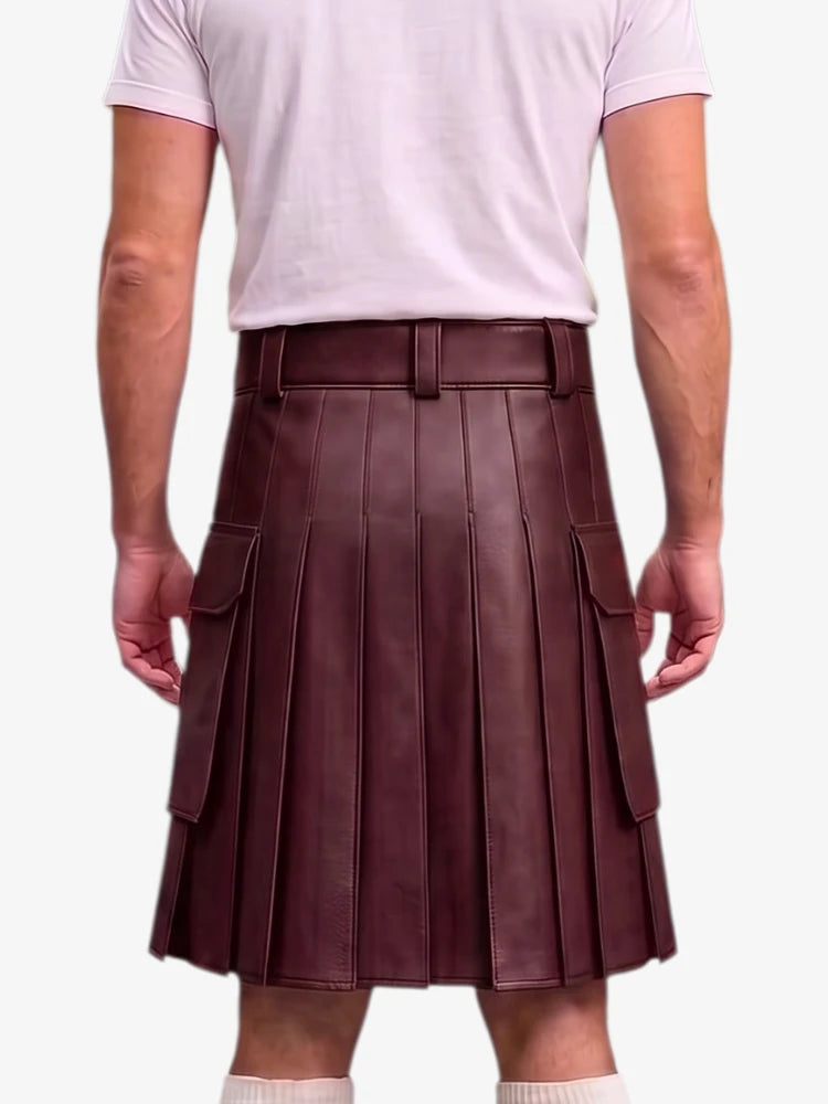 A person shown from the back wearing a pleated dark burgundy leather kilt with side flap pockets, paired with a light pink t-shirt and white socks, against a plain light gray background.