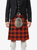 Person wearing a black jacket, red plaid kilt, and white socks on a white background