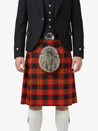 Person wearing a black jacket, red plaid kilt, and white socks on a white background