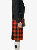 Person wearing a black jacket and red plaid kilt on a white background