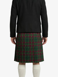 Person wearing a black jacket and green plaid kilt on a white background
