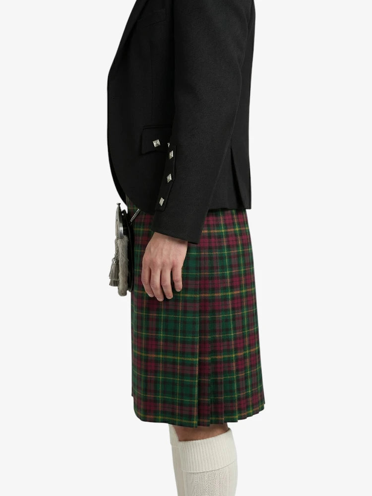 Person wearing a black jacket and green plaid kilt on a white background