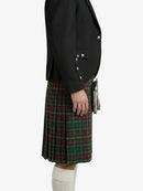 Person wearing a black blazer and green plaid kilt on a white background