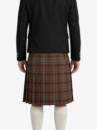 Person wearing a black jacket and plaid kilt on a white background