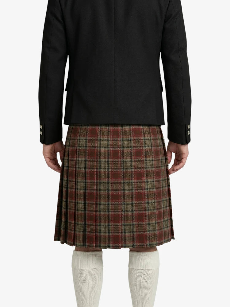 Person wearing a black jacket and plaid kilt on a white background