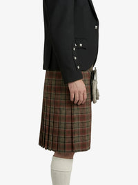 Person wearing a black jacket and plaid kilt on a white background
