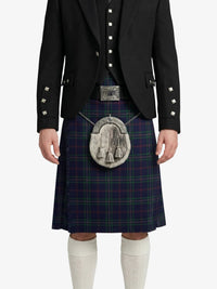 Person wearing a traditional Scottish kilt with a jacket on a white background
