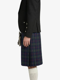 Person wearing a black jacket and plaid kilt on a white background