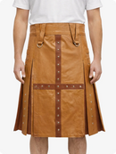 Camel leather skirt with brown straps and studs on a white background