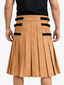 Camel pleated skirt with black straps worn by a person on a white background
