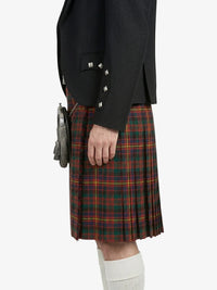 Person wearing a black jacket and red plaid kilt on a white background
