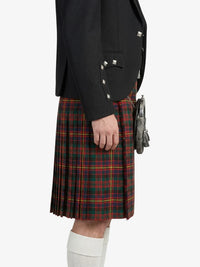Person wearing a black jacket and red plaid kilt on a white background
