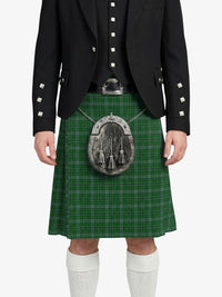 Person wearing a green plaid kilt with a black jacket on a white background