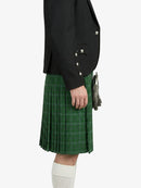 Person wearing a black jacket and green plaid kilt on a white background