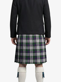 Person wearing a black jacket and green plaid kilt on a white background