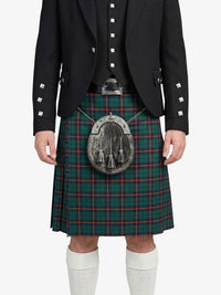 Person wearing a black jacket and green plaid kilt with a silver sporran on a white background