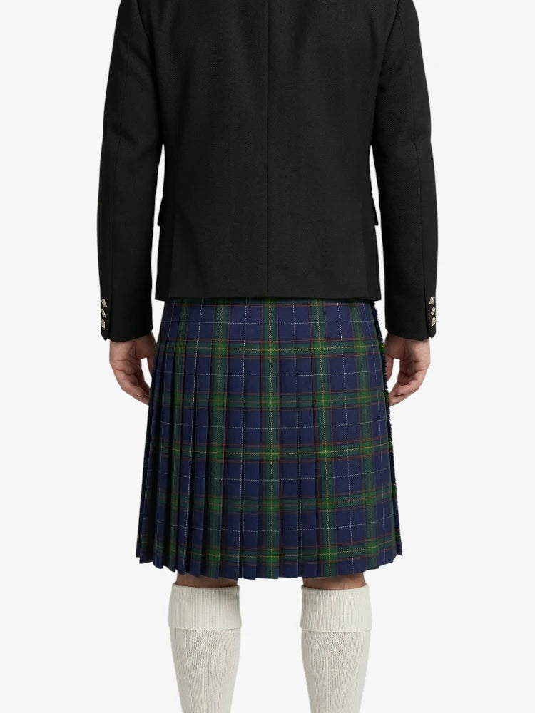 Person wearing a black jacket and blue plaid kilt on a white background