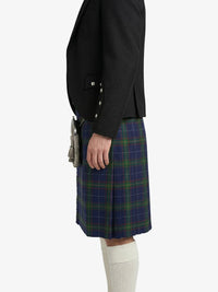 Person wearing a black jacket and blue plaid kilt on a white background