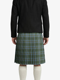 Person wearing a green plaid kilt with a black jacket on a white background