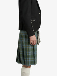 Person wearing a black jacket and green plaid kilt on a white background