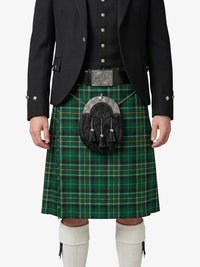 Person wearing a green plaid kilt with a black jacket on a white background