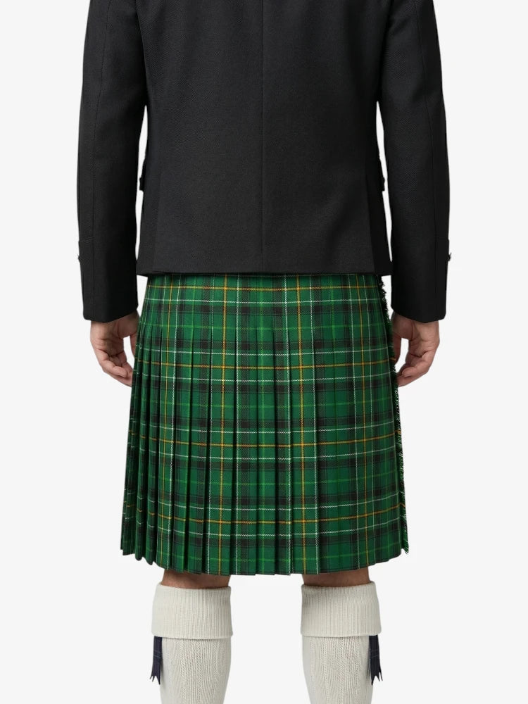 Person wearing a green plaid kilt with a black jacket on a white background