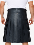Black pleated kilt worn by a person on a plain background
