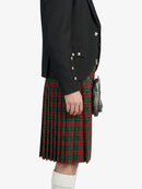 Person wearing a black jacket and red plaid kilt on a white background
