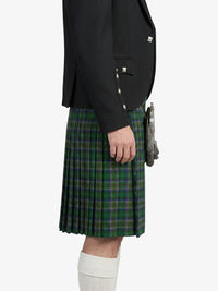 Person wearing a black jacket and green plaid kilt on a white background