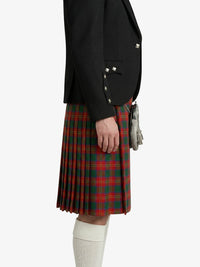 Person wearing a black blazer and red plaid kilt on a white background