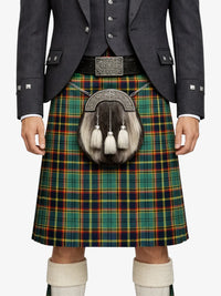 Person wearing a traditional Scottish kilt with a tartan pattern on a white background