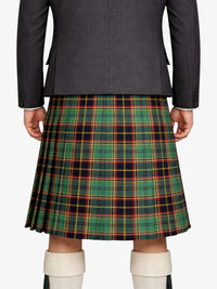 Person wearing a gray blazer and green plaid kilt on a white background
