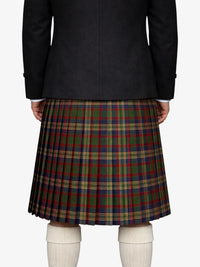 Person wearing a black jacket and plaid kilt on a white background