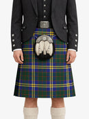 Person wearing a traditional Scottish kilt with a tartan pattern on a white background