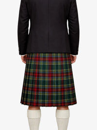Person wearing a black jacket and green plaid kilt on a white background