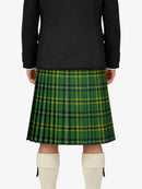 Person wearing a green plaid kilt with a black jacket on a white background