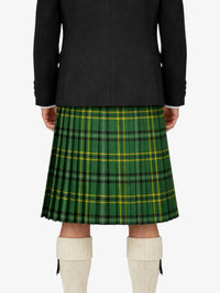 Person wearing a green plaid kilt with a black jacket on a white background